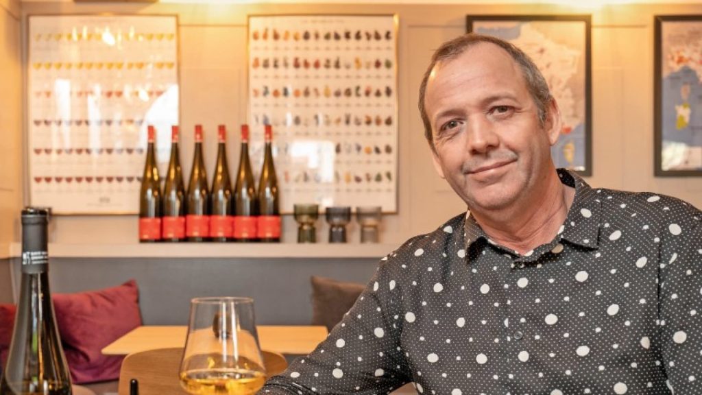 Inhaber Michel Briedé mit mit einem Glas Wein